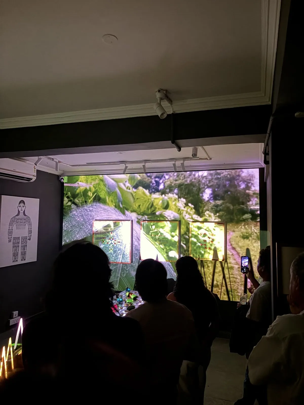 Guests watch a projection of the Cherrapunji landscape